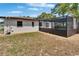 Backyard view featuring a screened-in pool, ideal for private outdoor relaxation and recreation, with manicured gravel surround at 3344 Blythe Ave, Spring Hill, FL 34609