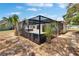 Exterior view of the screened-in pool area with palm trees enhancing the privacy and tropical ambiance, perfect for relaxation at 3344 Blythe Ave, Spring Hill, FL 34609
