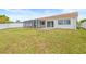 Spacious backyard with white fencing and screened patio, perfect for outdoor living at 3431 Springfield Dr, Holiday, FL 34691