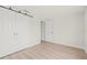 Bedroom featuring barn doors and light wood floors at 3431 Springfield Dr, Holiday, FL 34691