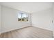 Bright bedroom with light wood floors and a large window at 3431 Springfield Dr, Holiday, FL 34691