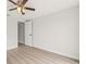 Bright bedroom with ceiling fan, light wood flooring, and white door and trim at 3431 Springfield Dr, Holiday, FL 34691