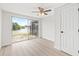 Bedroom featuring a ceiling fan and sliding glass doors leading to a lake view at 3431 Springfield Dr, Holiday, FL 34691