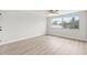 Well-lit bedroom with a ceiling fan and a large window offering a scenic view at 3431 Springfield Dr, Holiday, FL 34691