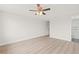Spacious bedroom featuring light wood floors and a ceiling fan at 3431 Springfield Dr, Holiday, FL 34691