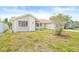Charming exterior with well-maintained lawn and inviting entrance to home at 3431 Springfield Dr, Holiday, FL 34691