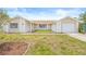 Charming single-story home featuring a brick pathway, neutral paint scheme, and a well-maintained front lawn at 3431 Springfield Dr, Holiday, FL 34691