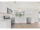 Modern kitchen featuring stainless steel appliances, bright white cabinets, and a sink with a backyard view at 3431 Springfield Dr, Holiday, FL 34691