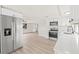 Modern kitchen featuring stainless steel appliances and ample counter space, connected to a bright living area at 3431 Springfield Dr, Holiday, FL 34691