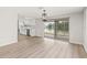 Open concept living area featuring light wood floors and sliding glass doors leading to outdoor patio at 3431 Springfield Dr, Holiday, FL 34691