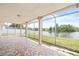 Enclosed patio with decorative tile and lake views at 3431 Springfield Dr, Holiday, FL 34691