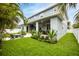 Spacious backyard featuring a covered patio, lush landscaping, and outdoor seating at 3611 W Royal Palm Cir, Tampa, FL 33629