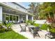 Inviting backyard with a patio, outdoor seating, landscaping and string lights at 3611 W Royal Palm Cir, Tampa, FL 33629