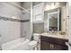 Clean bathroom featuring a tub, shower, and modern vanity with granite countertop at 3611 W Royal Palm Cir, Tampa, FL 33629