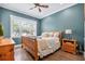 Comfortable bedroom with wood furniture, hardwood floors, and bright natural light at 3611 W Royal Palm Cir, Tampa, FL 33629