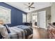 Spacious bedroom with hardwood floors and a partial view of the en-suite bathroom and desk at 3611 W Royal Palm Cir, Tampa, FL 33629