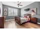 Comfortable bedroom featuring natural light, hardwood floors, and modern gray walls at 3611 W Royal Palm Cir, Tampa, FL 33629