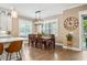 Bright dining room with large windows, modern light fixture, and hardwood floors at 3611 W Royal Palm Cir, Tampa, FL 33629