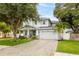 Beautiful two-story home with manicured lawn, paver driveway, and lush landscaping at 3611 W Royal Palm Cir, Tampa, FL 33629