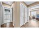 Bright hallway showcasing hardwood floors, white trim, and access to a bathroom and bedroom at 3611 W Royal Palm Cir, Tampa, FL 33629