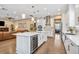 Modern white kitchen with stainless steel appliances, large island with a wine fridge, and open floor plan at 3611 W Royal Palm Cir, Tampa, FL 33629