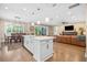 Bright open floor plan with kitchen island, stainless appliances, and access to the dining and living areas at 3611 W Royal Palm Cir, Tampa, FL 33629