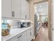 Stylish kitchen with white cabinets, marble countertops, and stainless steel appliances at 3611 W Royal Palm Cir, Tampa, FL 33629