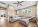 Spacious living room with a large sectional sofa and view into another bedroom at 3611 W Royal Palm Cir, Tampa, FL 33629