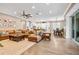 Spacious living room featuring an open floor plan, hardwood floors, and a large sectional sofa at 3611 W Royal Palm Cir, Tampa, FL 33629
