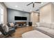 Spacious living room with a modern entertainment center, comfortable seating, and a contemporary ceiling fan at 3611 W Royal Palm Cir, Tampa, FL 33629