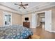 Relaxing main bedroom featuring a decorative ceiling, dresser, and a connecting door to the bathroom at 3611 W Royal Palm Cir, Tampa, FL 33629
