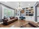 Elegant office featuring built-in bookshelves, hardwood flooring, and natural light at 3611 W Royal Palm Cir, Tampa, FL 33629