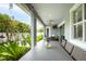 Covered patio with an outdoor dining area, fan, and garden views at 3611 W Royal Palm Cir, Tampa, FL 33629