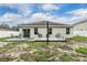 Spacious backyard featuring a weathered wood deck and views of the home's exterior at 3876 Crossline Dr, Spring Hill, FL 34609