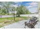 Backyard with seating on a wood deck, surrounded by grass and privacy fencing at 3876 Crossline Dr, Spring Hill, FL 34609