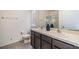 Bright bathroom featuring double sinks, modern faucets, and a decorative floral arrangement at 3876 Crossline Dr, Spring Hill, FL 34609