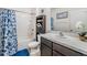 Charming bathroom with a tub/shower combination, storage cabinet, and sink with a white counter at 3876 Crossline Dr, Spring Hill, FL 34609