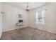 Minimalist bedroom with a simple desk, modern chandelier, and bright window at 3876 Crossline Dr, Spring Hill, FL 34609