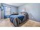 Serene bedroom with a comfortable bed, soft blue walls, and a view from the window at 3876 Crossline Dr, Spring Hill, FL 34609