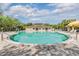 Large community swimming pool surrounded by a brick patio and lounge chairs at 3876 Crossline Dr, Spring Hill, FL 34609
