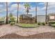 Stone community sign for Sterling Hill, surrounded by lush landscaping and palm trees at 3876 Crossline Dr, Spring Hill, FL 34609