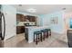 Stylish kitchen with dark cabinetry, a center island, and bar stool seating at 3876 Crossline Dr, Spring Hill, FL 34609