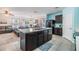 Open kitchen featuring a center island, stainless steel appliances, and a view to the living and dining areas at 3876 Crossline Dr, Spring Hill, FL 34609