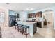 Bright kitchen with modern appliances, a large island, and seating for three at 3876 Crossline Dr, Spring Hill, FL 34609