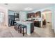 Stylish kitchen with a central island and bar stool seating, complemented by stainless steel appliances and light blue walls at 3876 Crossline Dr, Spring Hill, FL 34609