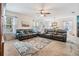 Cozy living room with neutral carpet, ceiling fan, and lots of natural light at 3876 Crossline Dr, Spring Hill, FL 34609