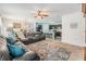 Spacious living room with dark sofa and an open-concept view of the kitchen at 3876 Crossline Dr, Spring Hill, FL 34609
