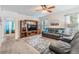Relaxing living room featuring a large entertainment center and neutral carpet at 3876 Crossline Dr, Spring Hill, FL 34609