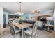 Open-concept living space that seamlessly connects the kitchen, dining area, and living room with plenty of light at 3876 Crossline Dr, Spring Hill, FL 34609