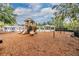 Community playground featuring slides, swings, and climbing apparatuses over mulch at 3876 Crossline Dr, Spring Hill, FL 34609